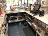 a laptop computer sitting on top of a desk in a store