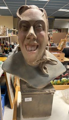 a bust of a man that is sitting on a table