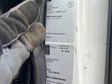 a close up of a person ' s glove on a washing machine
