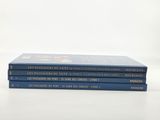 three books are stacked on top of each other on a table