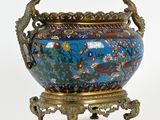 a large vase with a peacock on it on a stand