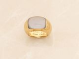 an image of a gold ring with a white stone