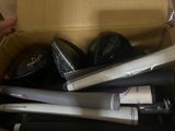 a box full of baseball bats and other sports equipment