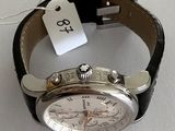 a watch with a price tag on it sitting on a table