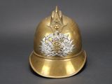 a gold helmet with a crest and a bird on it