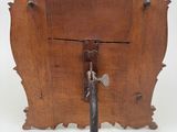 a small wooden frame with a handle on it