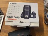 a box of canon eos 5000d sitting on a table next to a laptop
