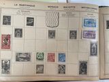 an open book with stamps on it on a table