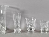 five glasses and a pitcher next to each other