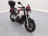 a red and white motorcycle parked in a white room