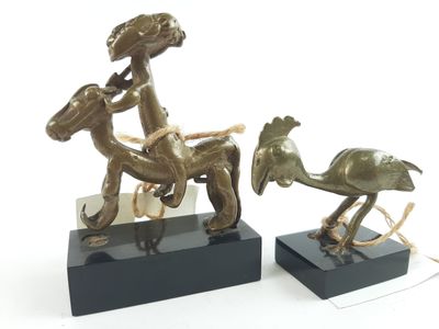 bronze figurines of a man riding a horse and a woman on a horse