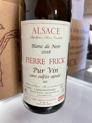 a bottle of wine sitting on a counter next to a box