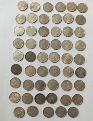 a close up of a pile of coins on a white surface