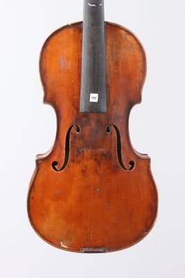 an old violin with a bow hanging from it ' s back