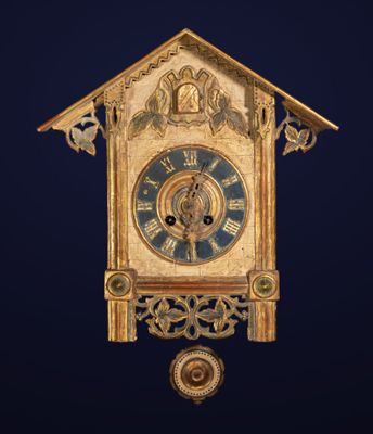 a clock hanging from the side of a building