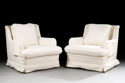 pair of white upholstered chairs with white cushions on a black background