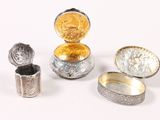 several different types of silver and gold jewelry on a white surface