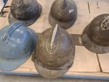five helmets sitting on top of a box in a warehouse