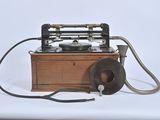 an old fashioned telephone with a cord attached to it