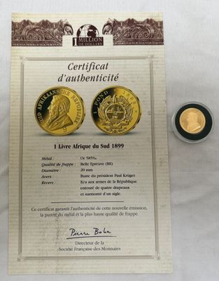 Deux pièces d'or sont posées à côté d'un certificat sur une table