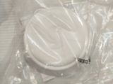 a white toilet in a plastic bag on the floor