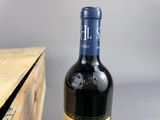 a bottle of wine sitting next to a wooden box