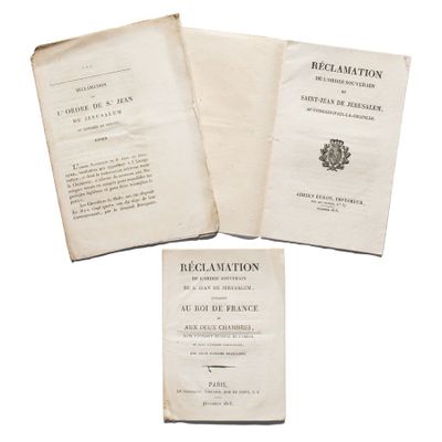 three old books sitting on top of each other on a white surface