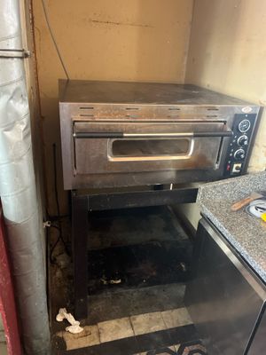 a small oven that is sitting in the corner of a kitchen