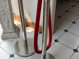two poles with red handles on them in a room