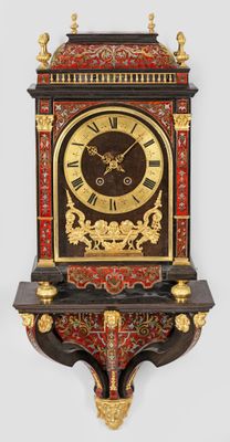 a clock that is sitting on a shelf on the wall