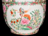 a large vase with a bird and flowers on it