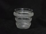 a clear glass cup with a handle on a black background