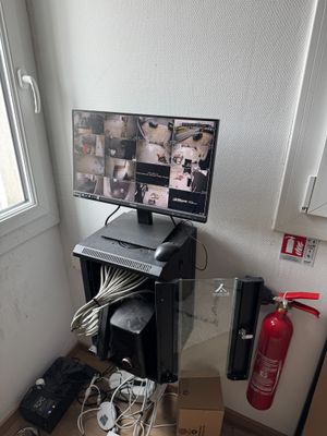 a desk with a computer monitor and a printer on it