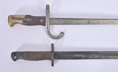 two knives that are on a white surface