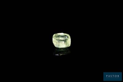 a close up of a green diamond on a black surface