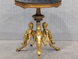 an image of a gold stool with a blue cushion on top of it
