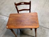 a small wooden table and a chair on the floor
