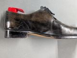 a pair of shoes hanging on a wall in a room