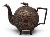 an old teapot with a handle on a white background