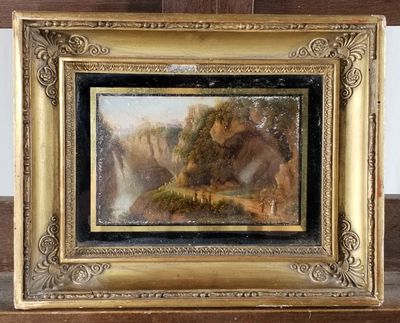 une image d'un tableau représentant une scène de montagne dans un cadre doré