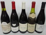six bottles of wine are lined up on a table