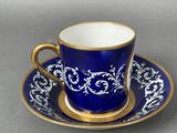 blue and white cup and saucer with gold trim