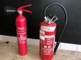 two fire extinguisors sitting on the floor next to each other