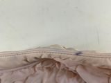 beige jacket with ruffles and zippers on the front