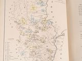 an open book with a map in it on a table