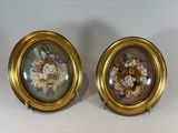 pair of gold framed floral paintings on a white background