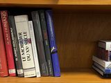many books on a book shelf in a library