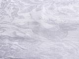a white towel on a table with a black background