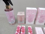 a bottle of perfume, a spray bottle, and other items on a table