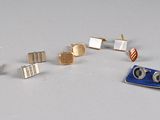 five pairs of earrings that are sitting on a table